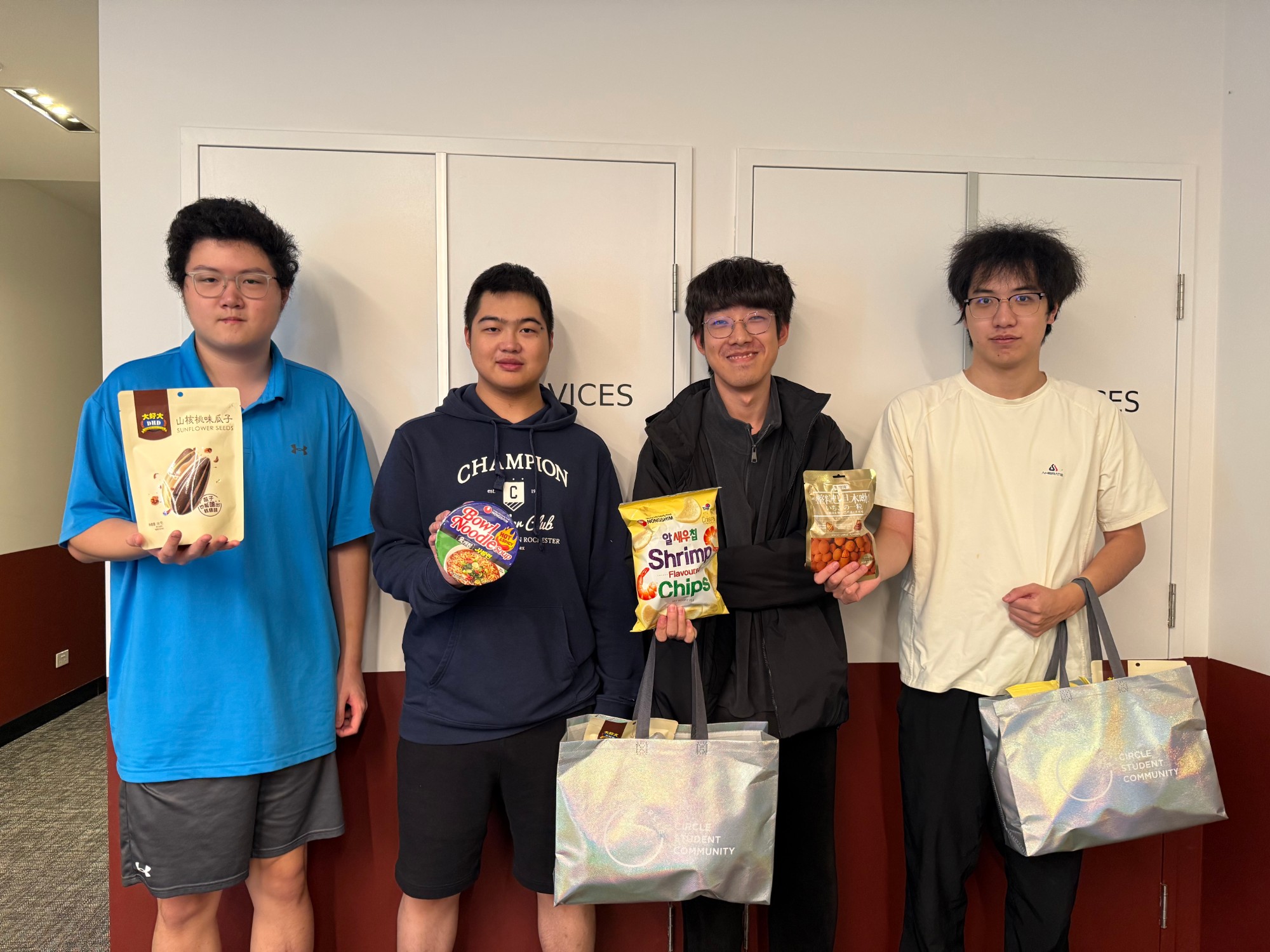Four Circle students holding snacks from their Mid-Autumn goodie bags